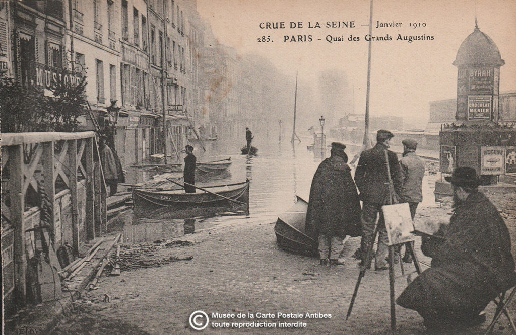 Carte postale ancienne représentant un peintre paysagiste à Paris quai des Grands Augustins lors des inondations de la Seine.
